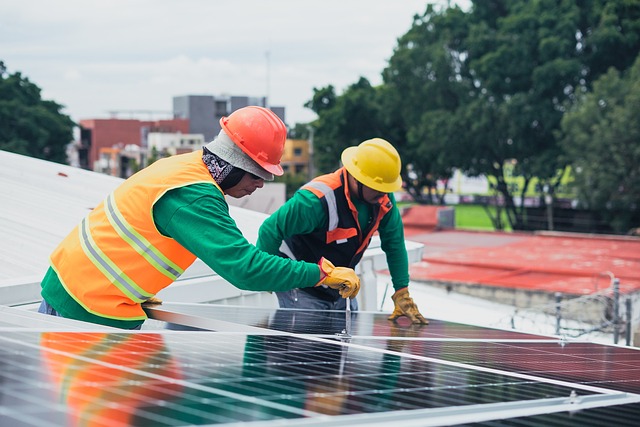 Close up view of two solar installers installing solar panels on the rooftop of a home in Las Vegas.